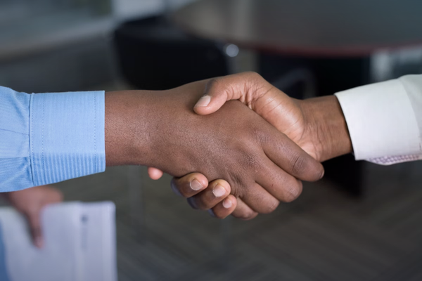 Business handshake representing customer success and commitment